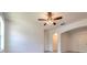 Bright living room with neutral walls, light-colored wood floors, arched doorway, and a ceiling fan with integrated lighting at 1218 Halapa Way, Trinity, FL 34655