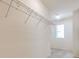 Walk-in closet features white walls, wood-look floors and wire shelving storage at 1218 Halapa Way, Trinity, FL 34655