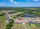 Aerial view of a residential neighborhood featuring houses with pools near a highway at 14239 Swiss Bridge Dr, Riverview, FL 33579