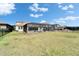 A spacious fenced backyard with a screened-in patio featuring a pool for relaxation and recreation at 14239 Swiss Bridge Dr, Riverview, FL 33579