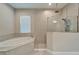 Bathroom showcasing a soaking tub and a walk-in shower at 14239 Swiss Bridge Dr, Riverview, FL 33579