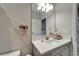 Neat bathroom with a vanity and an oval sink with a granite top, plus decor, and lots of light from the bulbs at 14239 Swiss Bridge Dr, Riverview, FL 33579