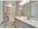 Bright bathroom with double vanity, bathtub, shower combo and patterned shower curtain at 14239 Swiss Bridge Dr, Riverview, FL 33579