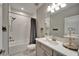 Bright, clean bathroom featuring a shower over the tub, a gray vanity, and coordinated decor for a relaxing space at 14239 Swiss Bridge Dr, Riverview, FL 33579