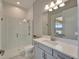 Modern bathroom featuring a glass-enclosed shower, vanity with a white countertop, and ample lighting at 14239 Swiss Bridge Dr, Riverview, FL 33579