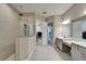 Modern bathroom with a glass shower, double vanity, and access to a walk-in closet at 14239 Swiss Bridge Dr, Riverview, FL 33579