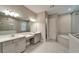 Bathroom showcasing double vanity, soaking tub, and walk-in shower at 14239 Swiss Bridge Dr, Riverview, FL 33579