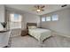 Comfortable bedroom with soft carpet, a ceiling fan, and natural light creating a relaxing atmosphere at 14239 Swiss Bridge Dr, Riverview, FL 33579