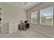 Bright bedroom with two windows, neutral carpet, and a desk, perfect for a home office or study space at 14239 Swiss Bridge Dr, Riverview, FL 33579