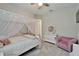 Stylish bedroom boasts a canopy bed, plush seating, and elegant décor, perfect for relaxation at 14239 Swiss Bridge Dr, Riverview, FL 33579