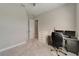 Spacious bedroom with plush carpeting, neutral walls, and a work space setup with windows for natural light at 14239 Swiss Bridge Dr, Riverview, FL 33579