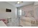 Charming bedroom featuring a canopy bed adorned with whimsical fairy lights and a wall-mounted television at 14239 Swiss Bridge Dr, Riverview, FL 33579