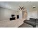 Open bonus room includes a ceiling fan, television, and comfortable seating with carpeted flooring at 14239 Swiss Bridge Dr, Riverview, FL 33579