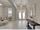 An elegant foyer with tile floors, a decorative mirror, and double doors with decorative wreaths at 14239 Swiss Bridge Dr, Riverview, FL 33579