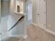 Bright hallway features neutral carpet, fresh paint, and a stairway with traditional railings at 14239 Swiss Bridge Dr, Riverview, FL 33579