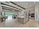 Open concept kitchen with gray cabinets, stainless steel appliances, large island, and view of the living area and pool at 14239 Swiss Bridge Dr, Riverview, FL 33579