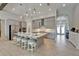 Spacious kitchen with gray cabinets, stainless appliances, and an island with seating, overlooking the entryway and buffet at 14239 Swiss Bridge Dr, Riverview, FL 33579