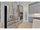 Stainless steel refrigerator and built-in oven/microwave with gray cabinets in a modern, open-concept kitchen at 14239 Swiss Bridge Dr, Riverview, FL 33579