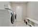 Well-organized laundry room with modern washer and dryer, shelving, and storage bench at 14239 Swiss Bridge Dr, Riverview, FL 33579