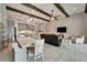Open-concept living space featuring wood beams, kitchen with an island, and ample seating at 14239 Swiss Bridge Dr, Riverview, FL 33579