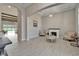 Bright living room with tile floors, a fireplace, a tray ceiling, and an archway leading to a pool at 14239 Swiss Bridge Dr, Riverview, FL 33579