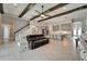 Open-concept living area with a kitchen, staircase, and wood beam ceiling at 14239 Swiss Bridge Dr, Riverview, FL 33579