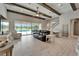 Bright living room with wood beam ceiling, tile floors, and view of pool at 14239 Swiss Bridge Dr, Riverview, FL 33579
