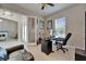 Bright office space with neutral paint, ceiling fan, modern black desk setup, and natural light from a window at 14239 Swiss Bridge Dr, Riverview, FL 33579