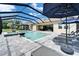Screened pool area includes a spa, lounge chairs, and lush landscaping, creating a private oasis at 14239 Swiss Bridge Dr, Riverview, FL 33579
