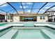 A luxurious screened-in pool features tile trim and steps for seamless relaxation at 14239 Swiss Bridge Dr, Riverview, FL 33579
