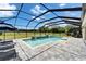 Enclosed pool area features a spa, stylish patio furniture, and views of the surrounding landscape at 14239 Swiss Bridge Dr, Riverview, FL 33579