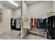 Walk-in closet with two sections of hanging clothes and a small set of drawers at 14239 Swiss Bridge Dr, Riverview, FL 33579