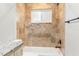 Well-lit bathroom with beige-tiled shower-tub and granite vanity at 145 Avon Dr, Safety Harbor, FL 34695