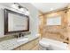 Bathroom with neutral vanity, granite countertop, and tiled shower and tub at 145 Avon Dr, Safety Harbor, FL 34695