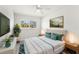 Airy bedroom featuring natural light, ceiling fan, and modern furnishings for a cozy ambiance at 145 Avon Dr, Safety Harbor, FL 34695
