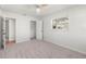 Bright bedroom features a ceiling fan, closet, and large window at 145 Avon Dr, Safety Harbor, FL 34695