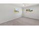 Bright bedroom featuring carpeted floors and large windows at 145 Avon Dr, Safety Harbor, FL 34695