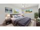 Comfortable bedroom featuring natural light, a ceiling fan, and cool-toned accents at 145 Avon Dr, Safety Harbor, FL 34695