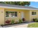 Close up of home showcasing updated paint, landscaping, and updated windows, providing a warm welcome at 145 Avon Dr, Safety Harbor, FL 34695