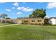 Cozy single-Gathering home with a spacious front yard, offering a welcoming entrance and outdoor space at 145 Avon Dr, Safety Harbor, FL 34695