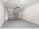 Empty garage with a painted floor and metal garage door at 145 Avon Dr, Safety Harbor, FL 34695