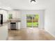 Bright kitchen features granite countertops, stainless steel appliances, and a sliding glass door to the backyard at 145 Avon Dr, Safety Harbor, FL 34695