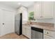 Functional kitchen with white cabinetry, stainless steel appliances, and granite countertops, offering both style and convenience at 145 Avon Dr, Safety Harbor, FL 34695