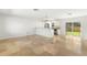 Spacious open-concept living room and kitchen area offering bright, neutral paint and tile flooring throughout at 145 Avon Dr, Safety Harbor, FL 34695