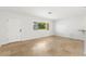 Bright, neutral living room space with tile flooring, window and door to welcome ample natural light at 145 Avon Dr, Safety Harbor, FL 34695