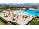 Community beach featuring white sand, lounge chairs, covered cabanas, and clear blue lagoon at 16927 April Plush Dr, Wimauma, FL 33598
