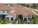 Aerial view of home with a brown tiled roof and screened-in patio at 16927 April Plush Dr, Wimauma, FL 33598