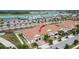 Aerial view of home complex near water park and manicured palm trees at 16927 April Plush Dr, Wimauma, FL 33598