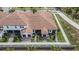 Aerial view of several properties featuring brown tiled roofs and manicured landscaping at 16927 April Plush Dr, Wimauma, FL 33598
