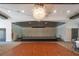 A performance stage in a large ballroom with chandeliers, wood floor, and stage at 16927 April Plush Dr, Wimauma, FL 33598